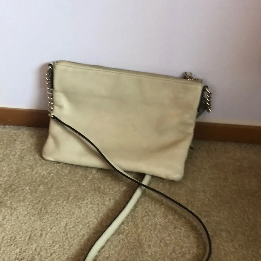 Kate Spade cream purse with a black bow